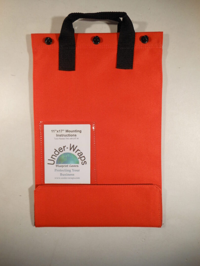A red bag with black handles and a card holder.