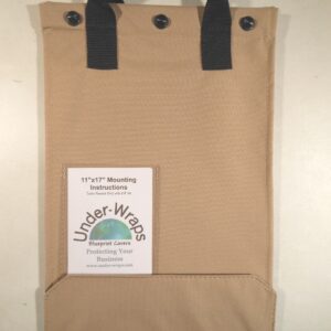 A brown bag hanging on the wall with some black handles.