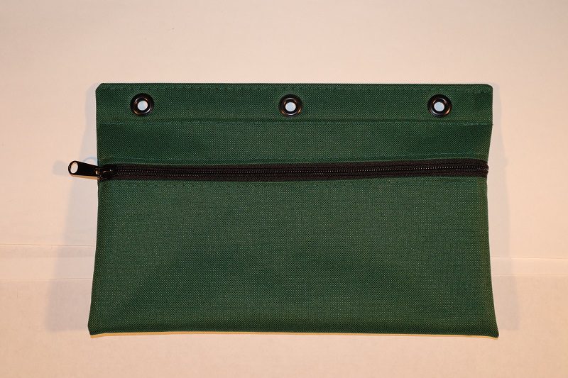 A green bag with three holes on the front.