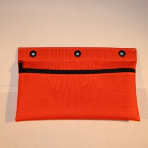 A red bag with three holes on the front.