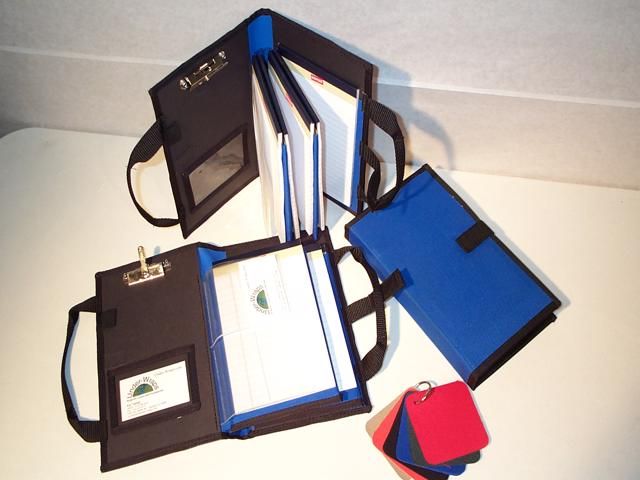 A group of three bags with papers and pens.