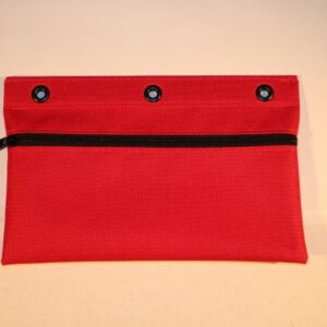 A red bag with three holes on the front.