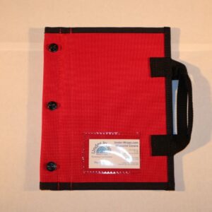 A red and black folder with some papers inside